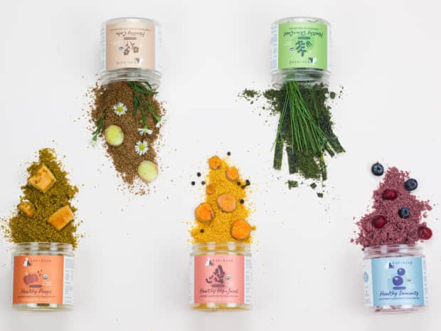 Image of kin + kind's pet supplements spilling out of containers