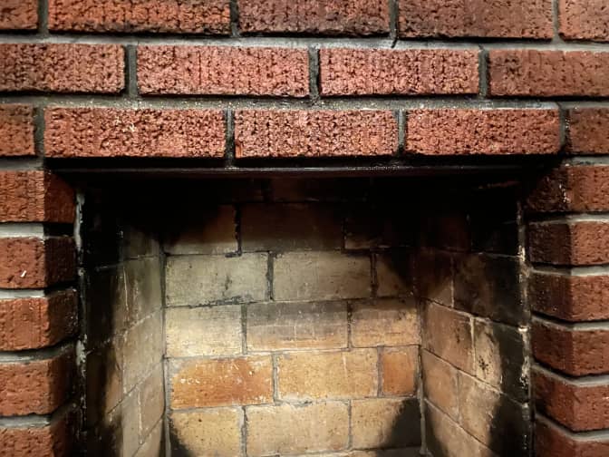 two rows of bricks in a fireplace cleaned with baking soda