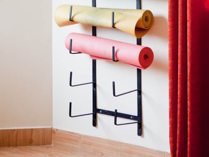 Yoga mats on rack on the wall