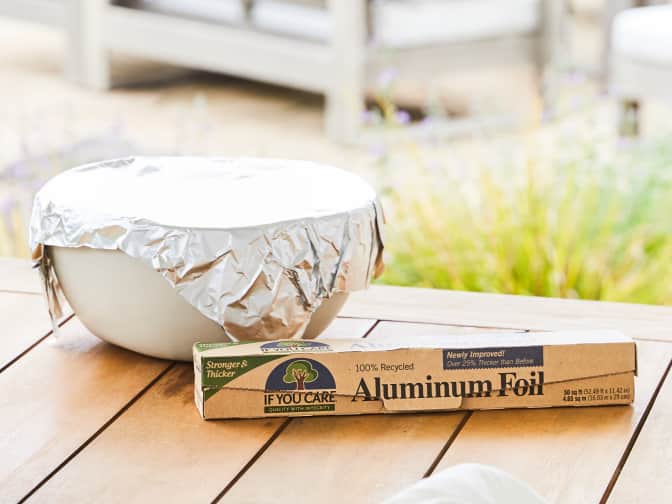 Image of recycled aluminum foil box with bowl covered in foil behind it