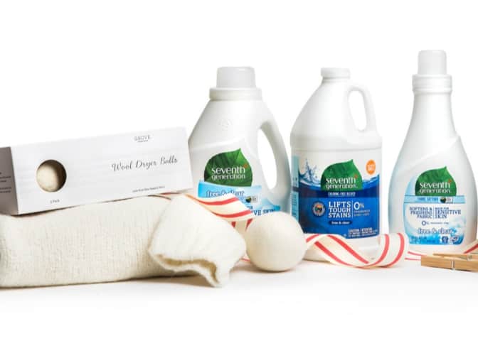 Image of Seventh Generation laundry products and wool dryer balls on top of white sweater