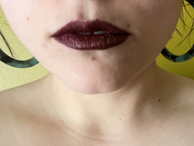 the author in a dark plum lipstick with chapped lips