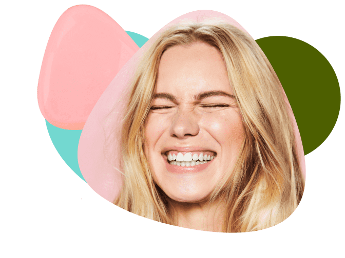 woman smiling in front of peach hair bar