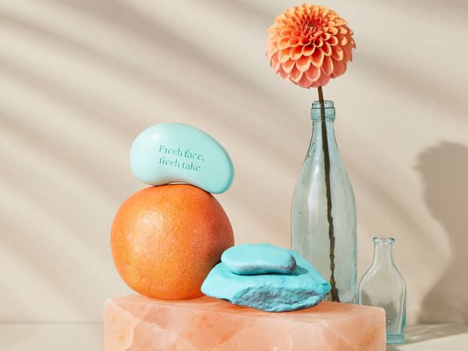 Image of Peach soap bars on table with vase with flower