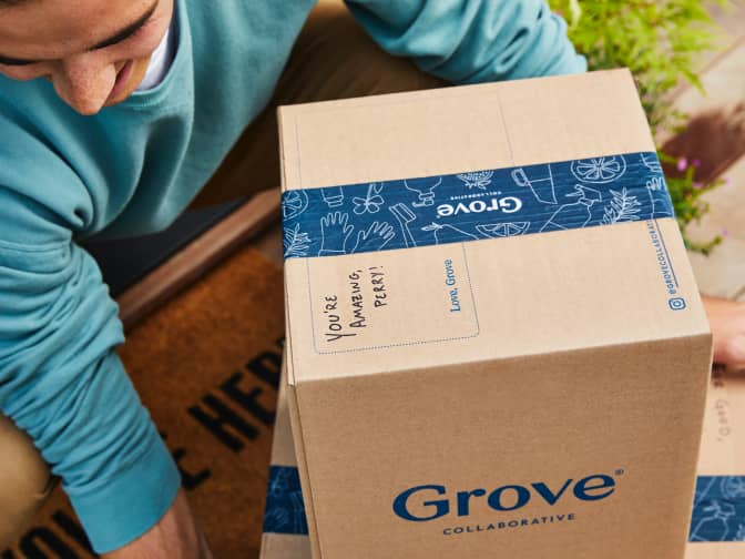 Man holding a stack of two Grove Collaborative boxes