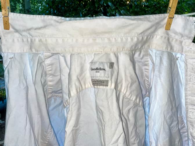 Photo of laundered white shirt hanging on clothesline