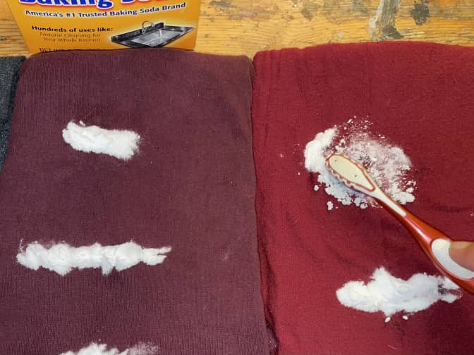 Three pieces of clothing having baking soda scrubbed in with a toothbrush.