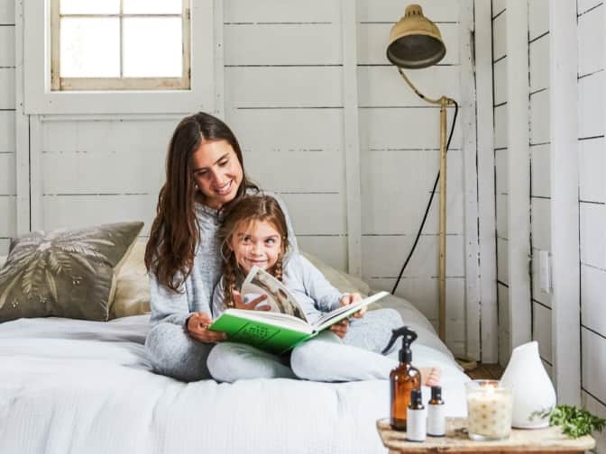 Image of a woman and child reading in a bed