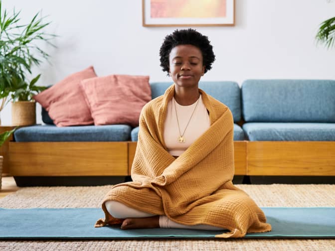 Woman meditating on a yoga mat