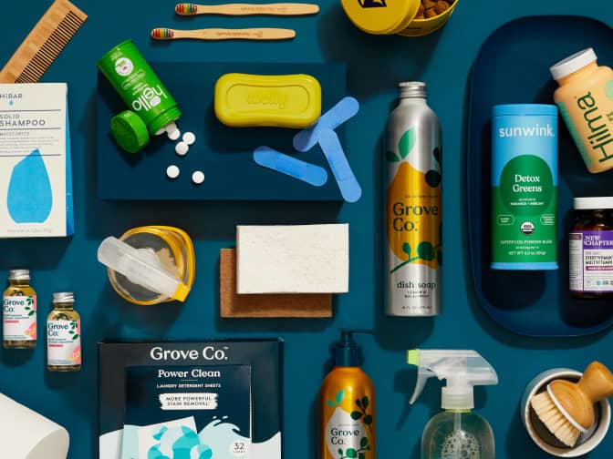 Image shows an assortment of product that grove carries on a navy blue background. Product includes: Grove Co cleaner concentrates, glass spray bottle, refillable soap, and laundry detergent sheets. Hibar shampoo bar, hello toothpaste tabs and more.