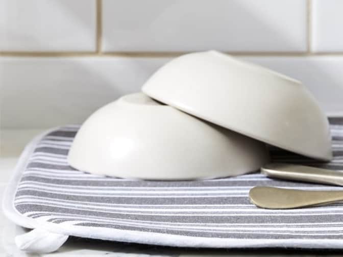 Photo of two bowls and utensils on a dish cloth