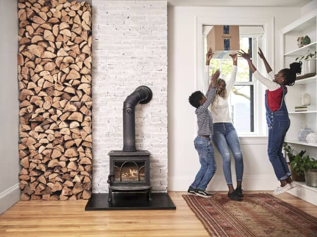 Image of three kids by a fireplace.