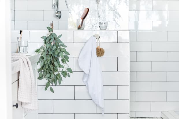 Photo of towels and eucalyptus hanging in bathroom