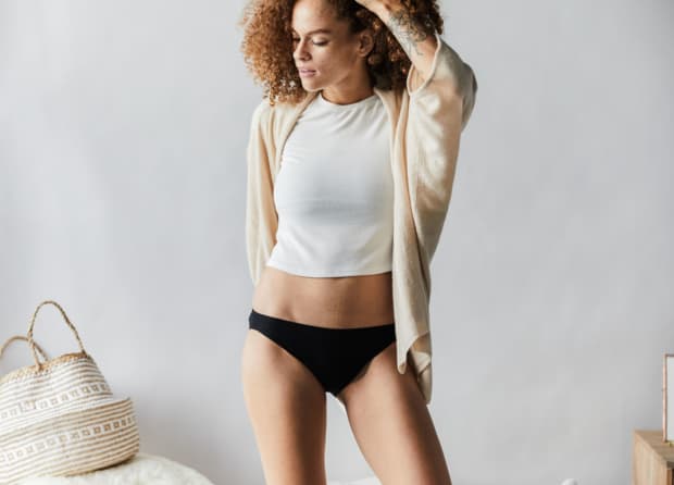 Photo of woman standing and wearing period underwear