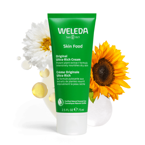 Weleda's Skin Food product with flowers behind it