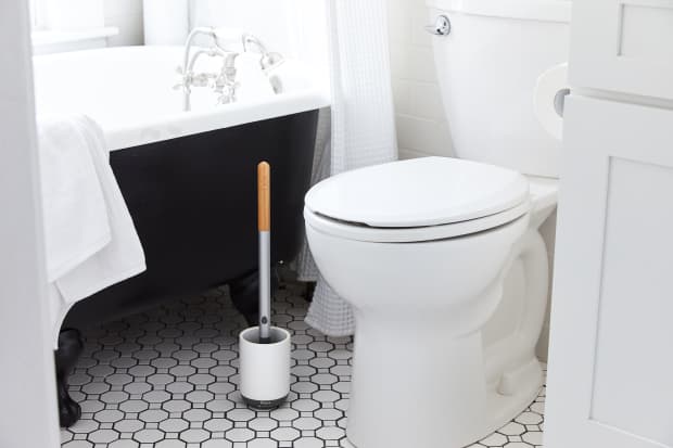 Image of a toilet with next to a toilet brush