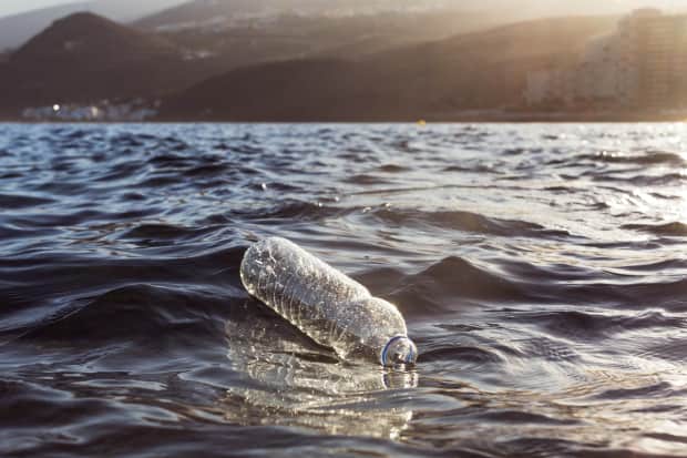 Plastic water bottle floating in the ocean