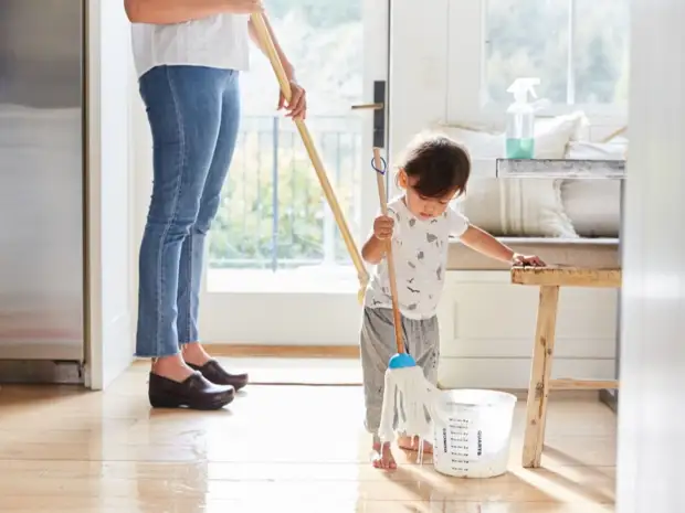 Woman and child mopping floor
