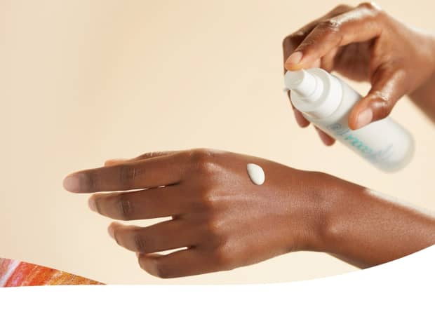 close-up of hands applying lotion
