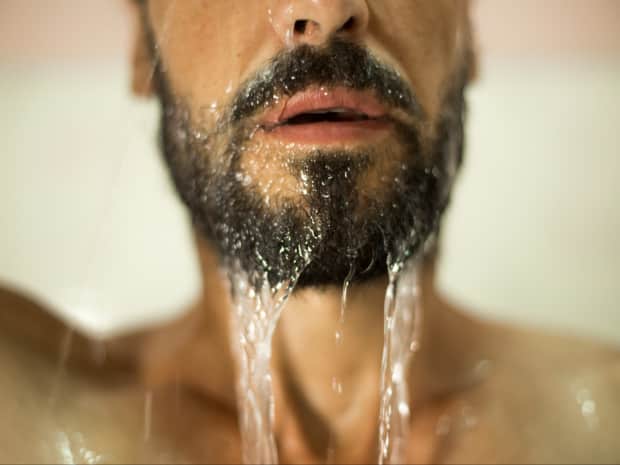 Photo of bearded man's face in shower
