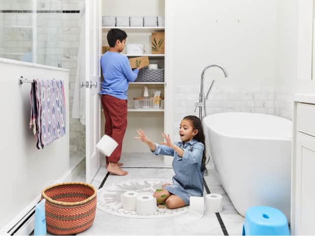 parent and child in bathroom, child throwing toilet paper roll